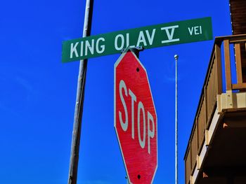 Low angle view of sign board against clear sky