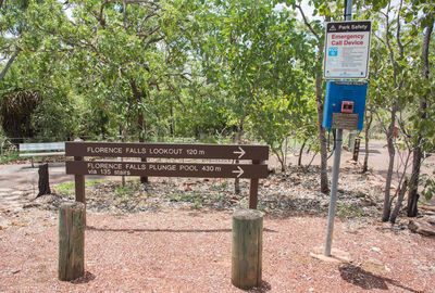 Information sign by trees in park