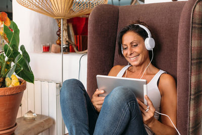 Smiling young woman using smart phone