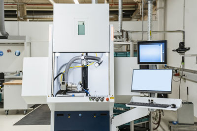 Control station of laser marking system inside modern factory, stuttgart, germany