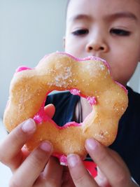 Close-up of boy having donut
