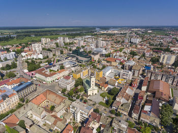 High angle view of townscape by sea against sky