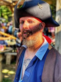 Portrait of man wearing hat standing outdoors
