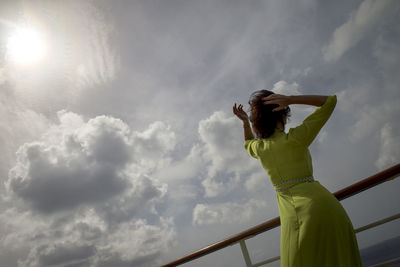 Low angle view of woman against sky