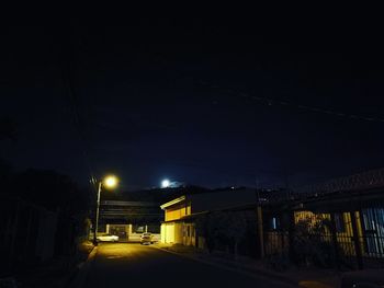 Illuminated road in city at night