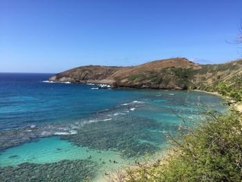 Scenic view of sea against clear blue sky