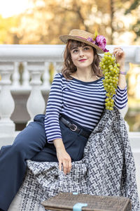 Portrait of young woman sitting on sofa