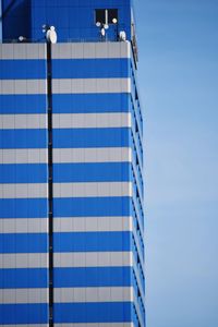 Low angle view of building against clear blue sky