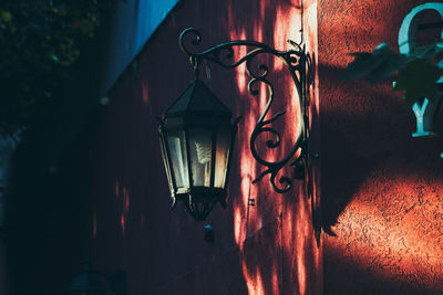 Sunlight falling on lamp post on building