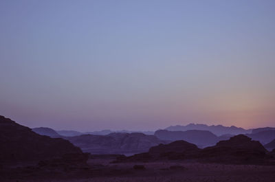 Scenic view of wadi rum against clear sky during sunset