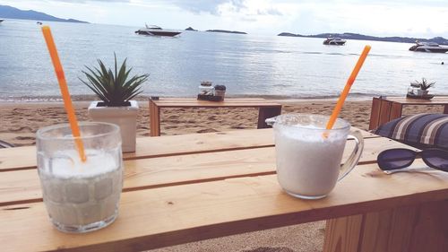 Close-up of drink on table at beach