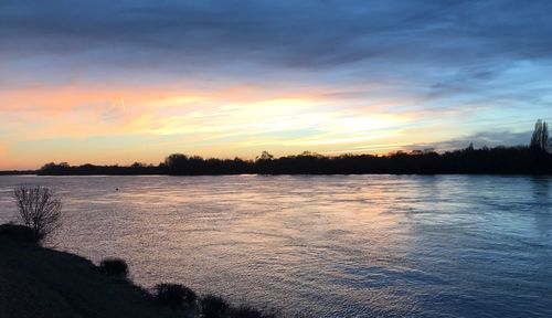 Scenic view of lake against sky during sunset