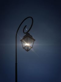 Optical illusion of illuminated street light on sunny day