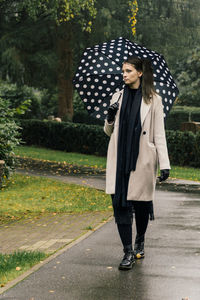 Full length of woman standing on road