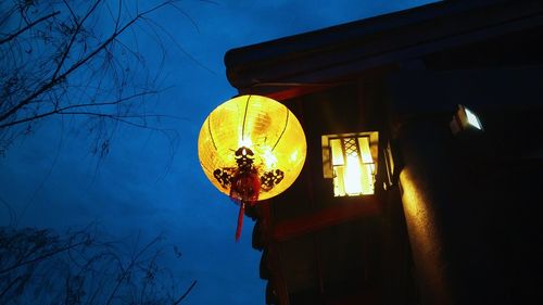 Low angle view of illuminated house against sky at night