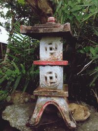 Close-up of birdhouse against trees