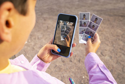 Woman taking photos through smart phone on sunny day