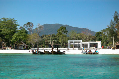 Longtail boats moored at shore of beach