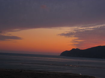Scenic view of sea against romantic sky at sunset