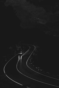 High angle view of road amidst trees at night