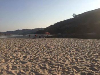 Scenic view of beach against clear sky