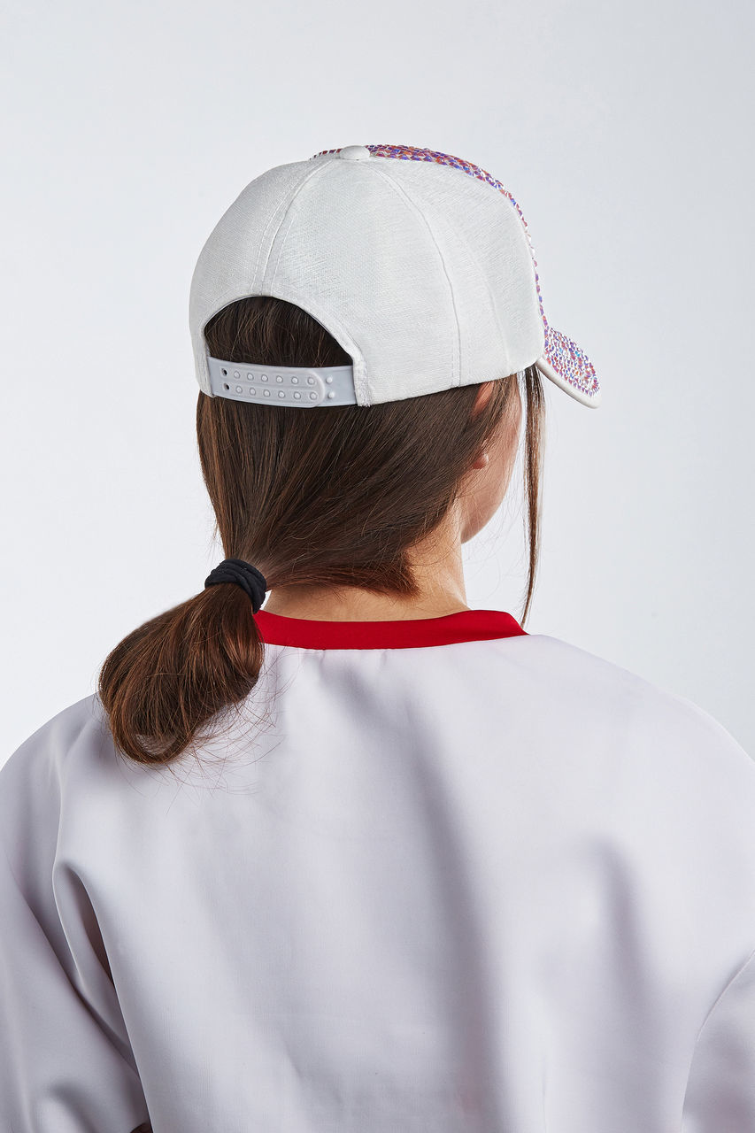 REAR VIEW OF WOMAN WEARING HAT