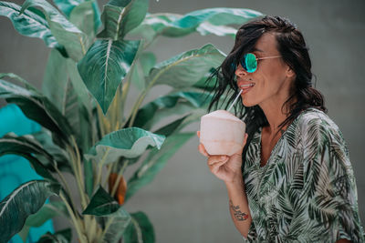 Midsection of woman drinking water