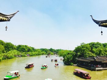 Boats in river against sky