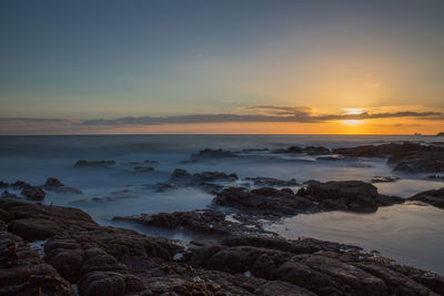 Scenic view of sea against sky at sunset