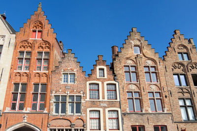 Low angle view of buildings against blue sky