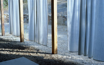 Close-up of hanging white linen drapes at a spa-like peaceful resort in ramona, california 