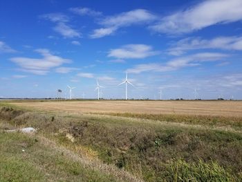 Scenic view of field against blue sky