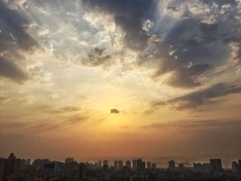 Low angle view of cityscape against sky during sunset