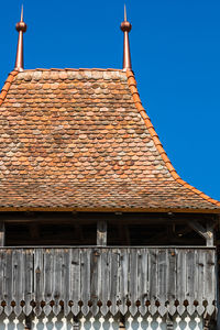 Low angle view of roof tiles against building