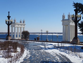 View of snow covered city against clear sky