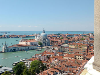 High angle view of city by sea against sky