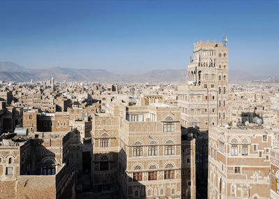 Old buildings in city against sky