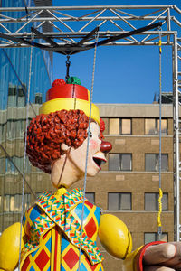 Low angle view of puppet against multi colored building