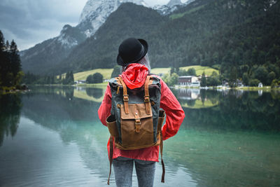 Woman standing on lake during rainy day