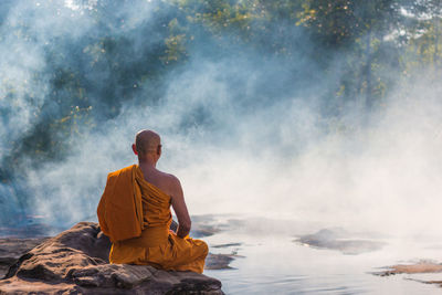 Buddhist monk on waterfront