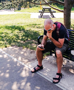 Full length of man sitting in park