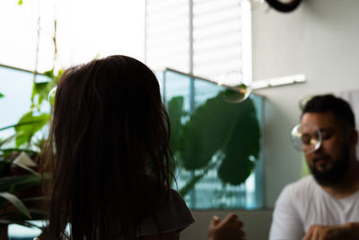 Girl playing with bubbles at home