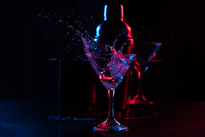 Close-up of wine glass on table against black background