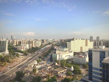 High angle view of modern buildings in city against sky