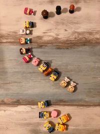 High angle view of toys playing with toy on wooden floor