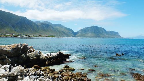 View of calm sea against mountain range