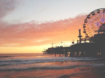 Pier on sea at sunset