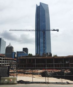 Construction site against cloudy sky