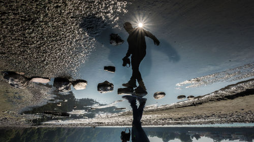 People on sea shore against sky