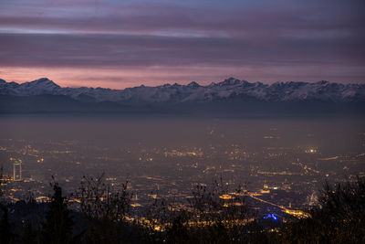 High angle view of illuminated city against sky during sunset